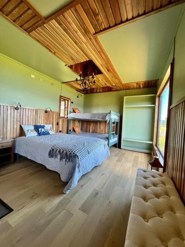 a bedroom with a bed and a wooden ceiling at Panguipulli Bella Vista in Panguipulli