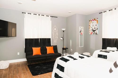 a bedroom with two beds and a couch at The Philly Factory! in Philadelphia