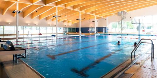 a large swimming pool with people swimming in it at Perle am Vierwaldstättersee in Fluelen