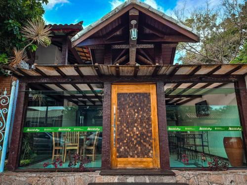 a front door of a restaurant with a cross on it at Pousada Abacateiro in Búzios