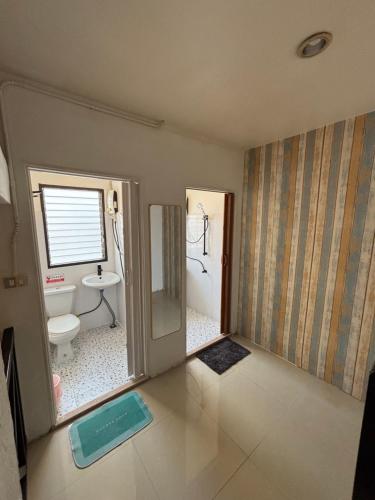 a bathroom with a toilet and a sink at La Locanda in Bangkok