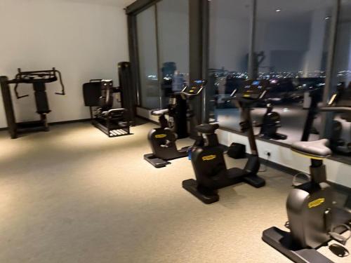 a gym with several treadying machines and a view of the city at Loxwood Apartment Tetteh Quashie Accra Ghana in Accra