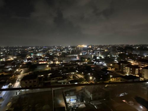 a view of a city at night with lights at Loxwood Apartment Tetteh Quashie Accra Ghana in Accra