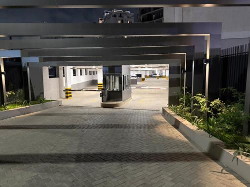 a walkway leading into a building with a parking lot at Loxwood Apartment Tetteh Quashie Accra Ghana in Accra