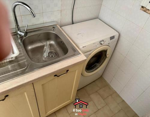 a kitchen with a sink and a washing machine at Casa Bianca bnb,Big Terrace,10 min Airport Beaches in Bitonto