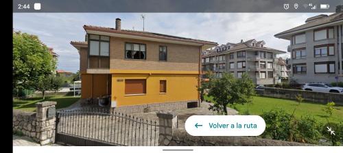 a yellow house with a text box in front of it at Villa La Rufina Noja in Noja