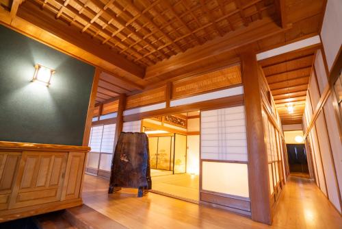 a hallway of a building with wooden walls and wooden floors at VacationHouse朔 海街さんぽ道 in Nahari