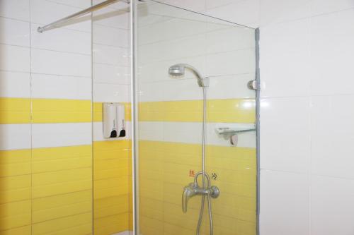 a shower with a glass door in a bathroom at 7Days Inn Huludao Railway Station Square in Huludao