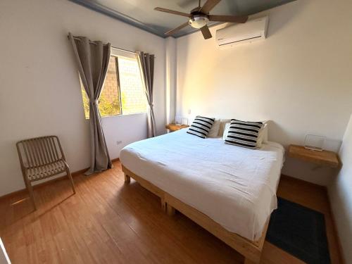 a bedroom with a bed with two pillows and a window at Estudio Terraza - Todos Santos - Centro in Todos Santos