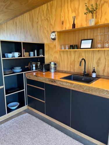 a kitchen with a sink and a counter at Tau Studio - Boutique Accommodation in Ohakune