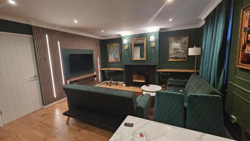 a living room with a couch and a television at Luxurious Flat 19min from London, 7min to station in Harrow