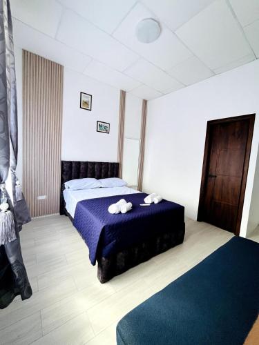 a bedroom with a bed with two towels on it at Blue house in Puerto Ayora