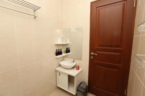 a bathroom with a sink and a shower at Rivera Villa Seminyak in Seminyak