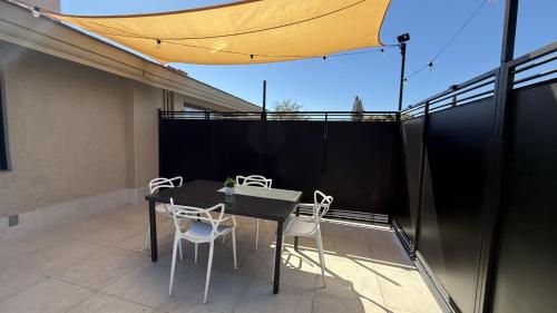 a patio with a table and chairs on a balcony at San Angel Villas in San Antonio