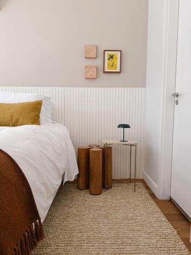 a bedroom with a bed and a table with a lamp at 2BR Heart of Leblon with Balcony, Renovated Gem in Rio de Janeiro