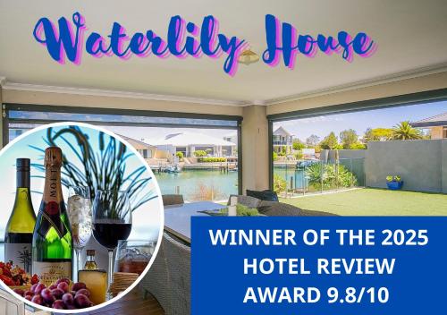 a house with a table with wine bottles and grapes at "WATERLILY HOUSE" - Luxury Canal House, Jetty, Dog & Child Friendly - Sleeps 14 in Mandurah