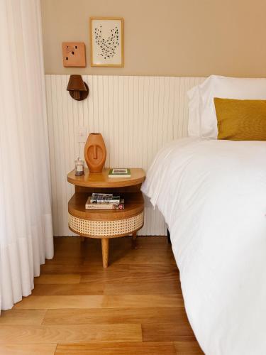 a bedroom with a bed and a nightstand next to a bed at 2BR Heart of Leblon with Balcony, Renovated Gem in Rio de Janeiro