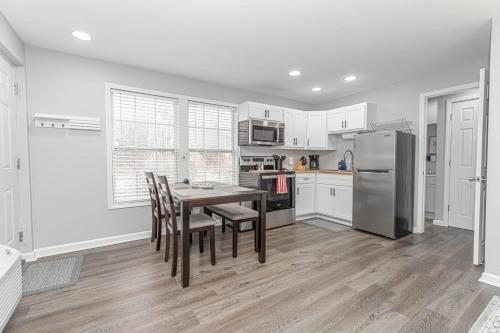 a kitchen with a table and chairs and a refrigerator at Downtown Kimmswick Studio-Renovated-Prime Location in Imperial
