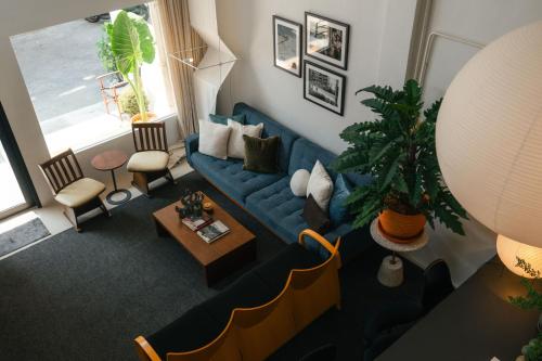 an overhead view of a living room with a blue couch at nap in a blue moon in Bangkok