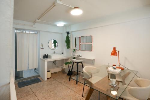 a bathroom with a glass table and a sink at nap in a blue moon in Bangkok