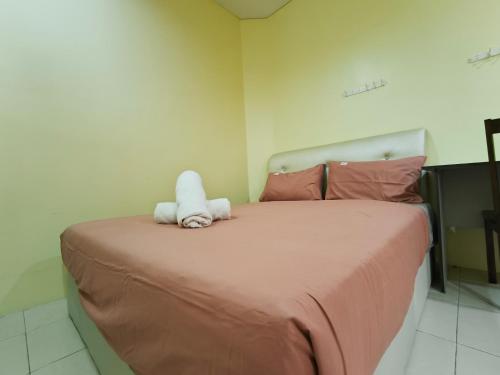 Ένα ή περισσότερα κρεβάτια σε δωμάτιο στο Natol Homestay - Moyan Batu Kawa
