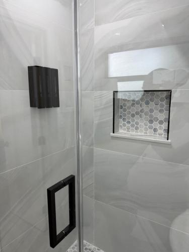 a shower with a glass door and a window at Dania Club Luxury Rentals in Dania Beach