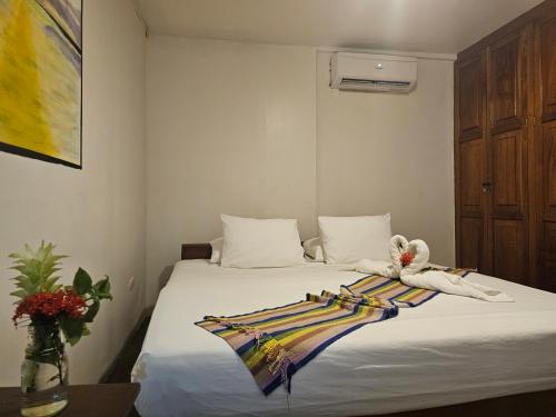 a bedroom with a bed with a towel on it at Nuestra Casa in San Juan del Sur