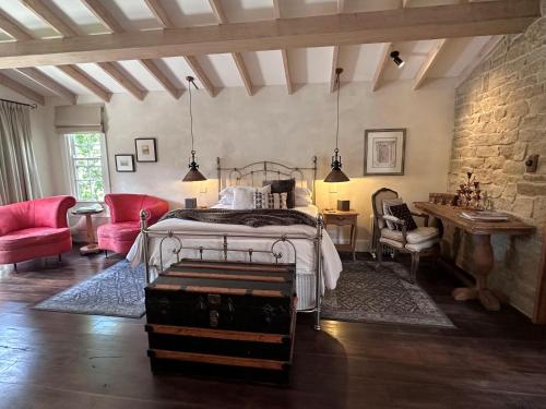 a bedroom with a bed and a stone wall at Guestlands Italia B&B in Arcadia