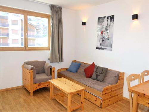 a living room with a couch and a table at Flat in Nendaz near Ski Lift & Slopes in Nendaz