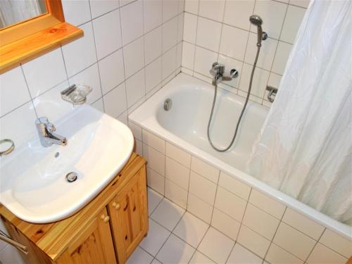 a bathroom with a sink and a shower and a tub at Flat in Nendaz near Ski Lift & Slopes in Nendaz