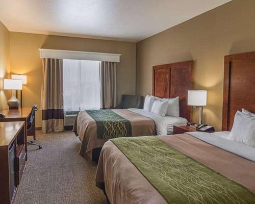 a hotel room with two beds and a window at Comfort Inn in Midland