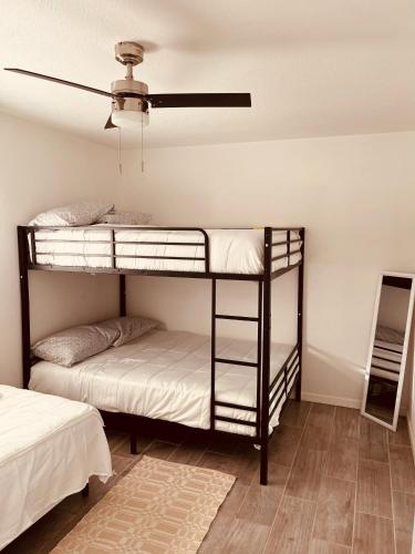 two bunk beds in a room with a ceiling at Cozy 2-BR Retreat in Kingman, AZ in Kingman