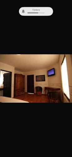 a living room with a television and a table and chairs at Villa villar in Querétaro