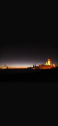 a view of a lit up building at night at Villa villar in Querétaro