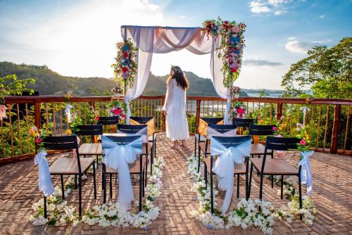 a bride is standing under an arch at a wedding ceremony at Golo Nuk in Komodo Labuan Bajo Airport