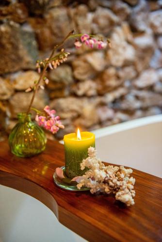 a candle sitting on top of a wooden table at Golo Nuk in Komodo Labuan Bajo Airport