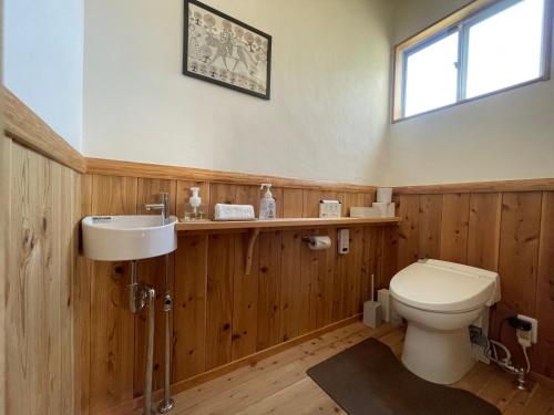 a bathroom with a toilet and a sink at ATASHIKADAYS Kumano-Kodo Beachfront B&B Hostel in Kumano