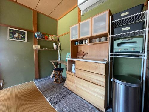 a small kitchen with a sink and a counter at ATASHIKADAYS Kumano-Kodo Beachfront B&B Hostel in Kumano
