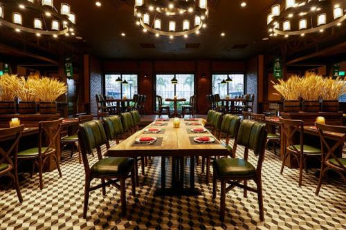 a dining room with a long table and chairs at The Manor Crown T12 in Thôn Trường Giang