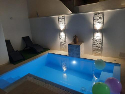 a swimming pool in a room with balloons and lights at VILLA PERLA del SALENTO con piscina in Lido Marini