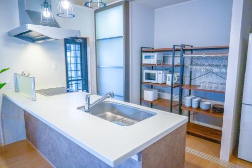 a kitchen with a sink and a counter top at Villa MILA MOTOBU in Motobu