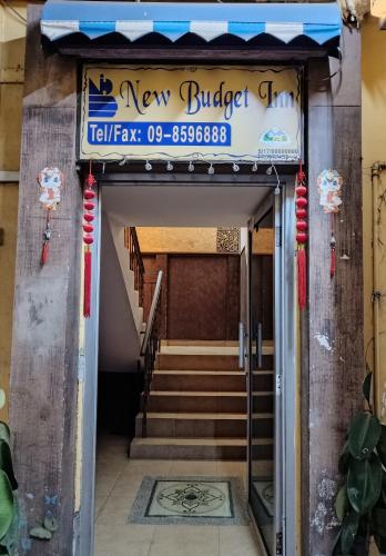 a building with a sign for a new buffalo grill at New Budget Inn Hotel in Cukai