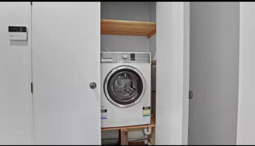 a washer and dryer sitting in a room at Lakefront House Stunning Sunsets in Waitahanui