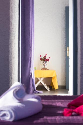 a room with a table with a vase of flowers at Smarula Villa in Firostefani