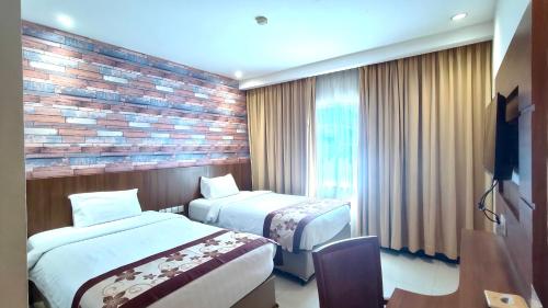 Sahid Batam Center Hotel and Conventionにあるベッド