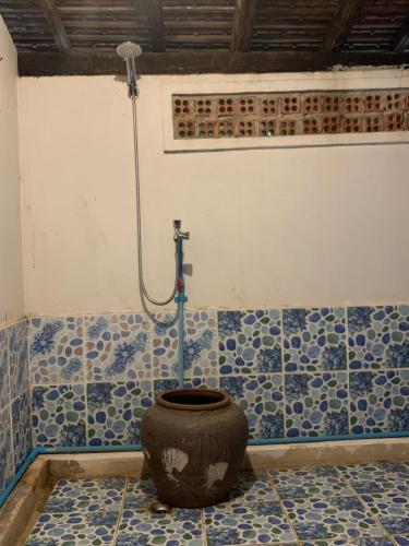a bathroom with a toilet with a shower in it at Chanmolfarmstay in Phumĭ Chŭb Chănt Sâr