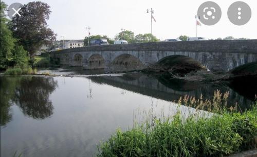 a bridge over a river with some cars on it at Ballyhoura Country Kildorrery, beautiful 5 bed in Kildorrery