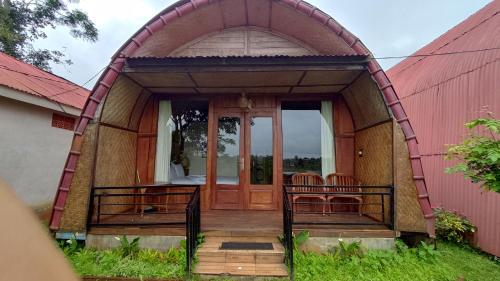 a small dome house with two chairs in it at Villa Gajah Mas in Baturiti