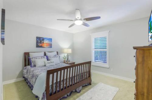 a bedroom with a bed and a ceiling fan at 1209 Marco Island in Marco Island