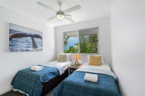 a bedroom with two beds and a ceiling fan at Sails Lifestyle Resort in Peregian Beach